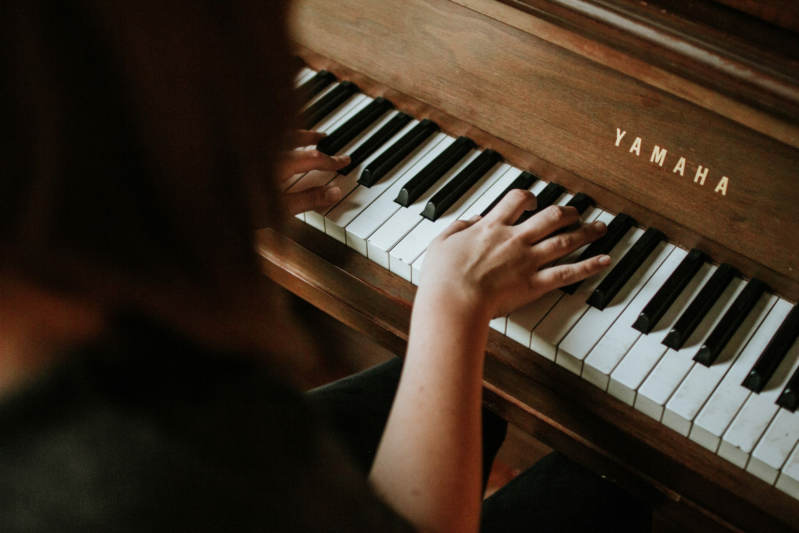 woman playing a Yamaha piano