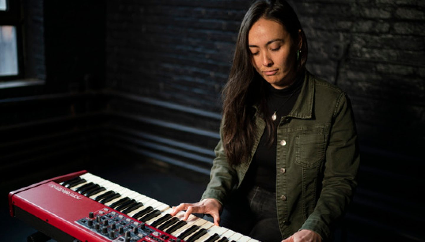 Online piano lesson scene with student and teacher on video call