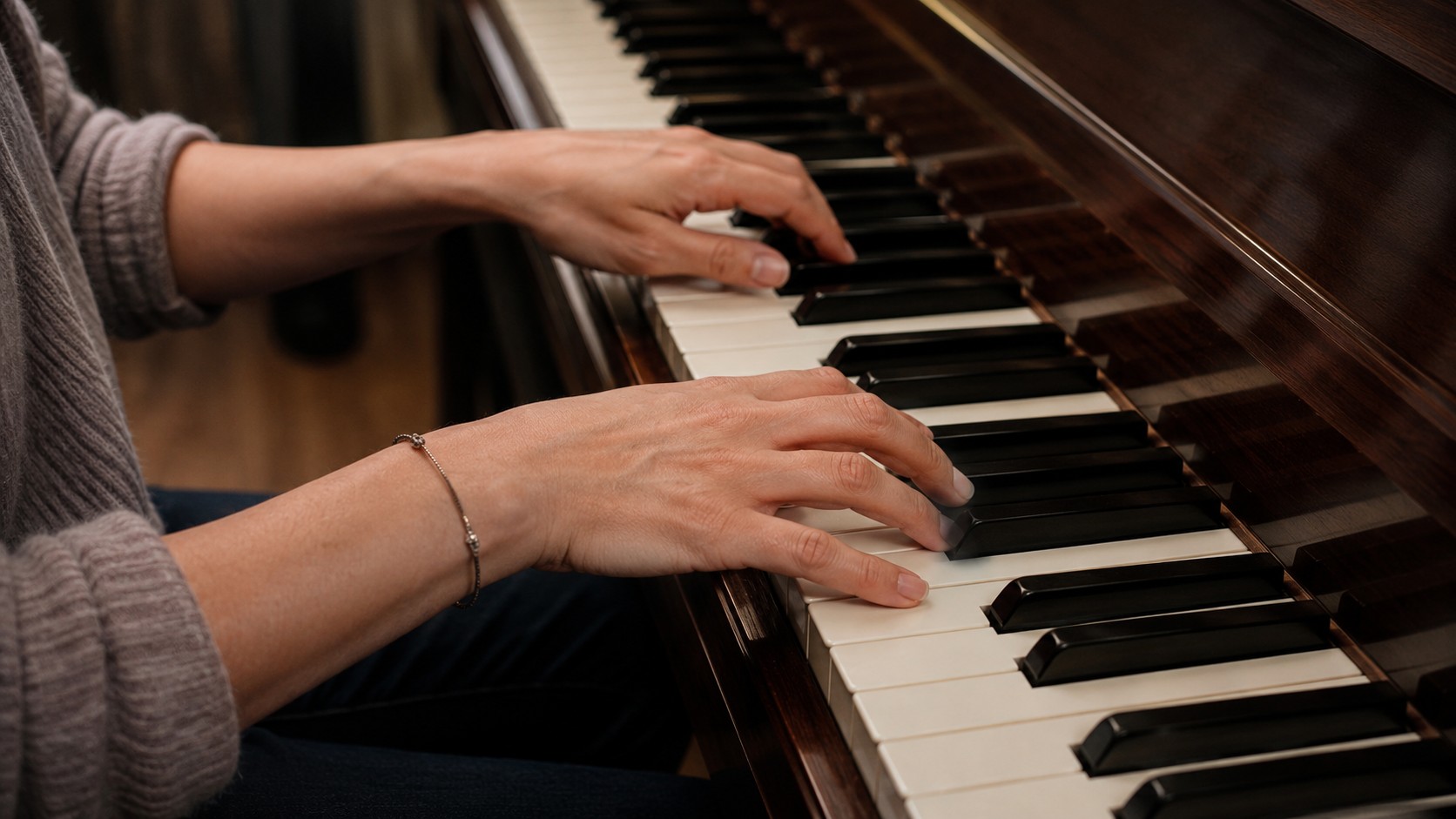 Close-up of hands in correct beginner position on piano keys